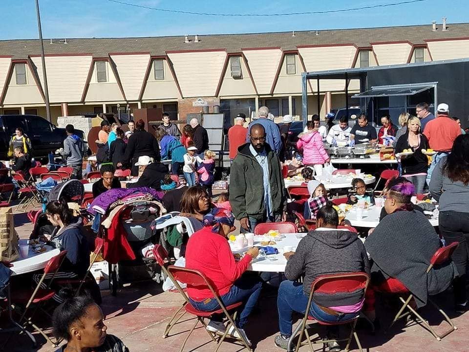 people eating at an outdoor cookout